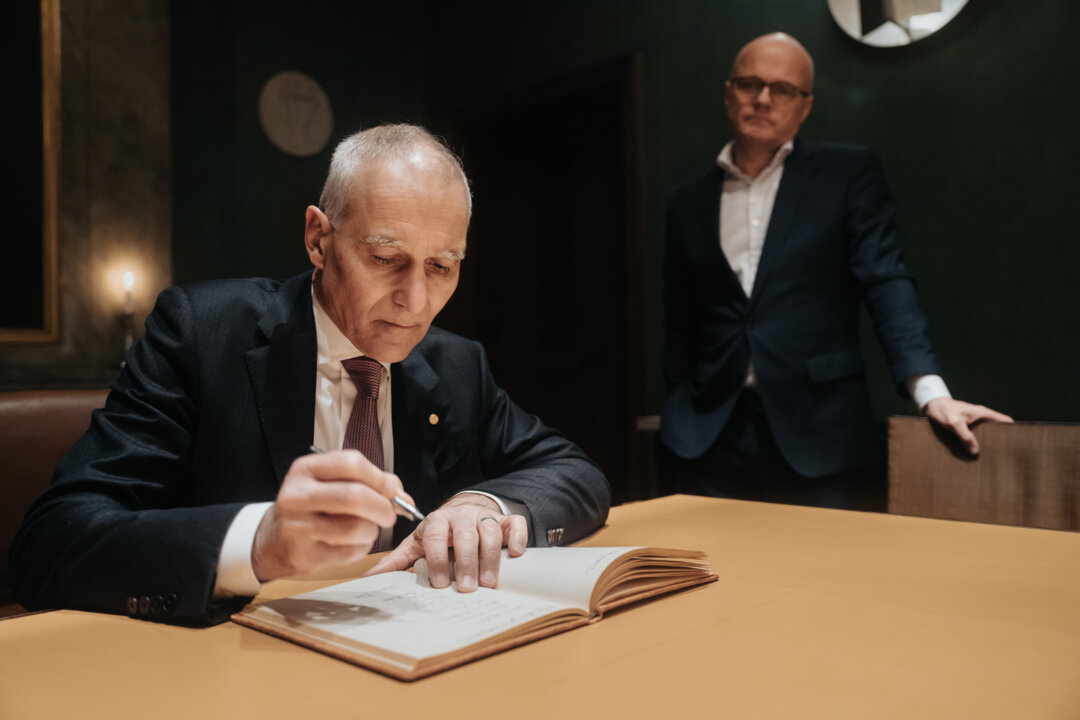 A man signs a guest book